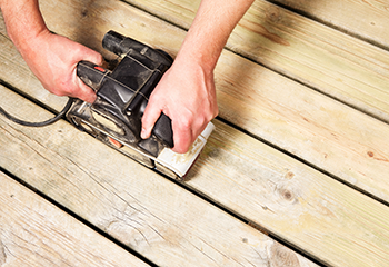 Professional deck sanding in progress on a home patio in Redondo Beach.